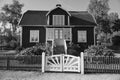 Swedish in black and white shot. tratitional house in Smalland,fence, garden, sky