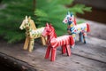 swedish dala horses on a pine wood surface