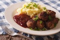 Swedish food: meatballs, lingonberry sauce with potato garnish. Royalty Free Stock Photo