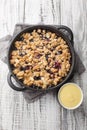 Swedish Fruit Crumble Pie Smulpaj with home made vanilla sauce closeup. Vertical top view Royalty Free Stock Photo