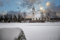 Swedish small white church by a lake in a cold winter landscape with snow Royalty Free Stock Photo