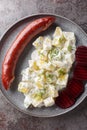 Swedish Isterband pork sausage with creamed potatoes with dill and boiled beets close-up on a plate. vertical top view Royalty Free Stock Photo