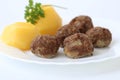 Swedish Kottbullar meatball with boiled potatoes and parsley on white plate on white background Royalty Free Stock Photo