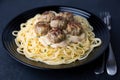 Swedish noisettes (fricandel) with spaghetti and Brune Sos creamy sauce. Traditional meatballs with garnish.