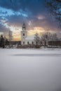 Swedish small white church by a lake in a cold winter landscape with snow Royalty Free Stock Photo