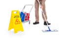 Sweeper cleaning floor with warning sign