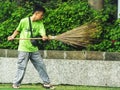 A sweeper doing his daily routine job. Cleaning the surrounding outdoor park.