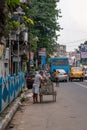 A sweeper sweeps the street of Kolkata, India on October 2020 Royalty Free Stock Photo