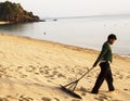 Sweeping the beach Royalty Free Stock Photo