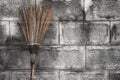 Sweeping broom with brick wall Royalty Free Stock Photo