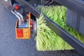 Big yellow round broom of street sweeper with wide sweeping path and maintains contact with pavement