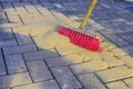 Sweeping in joint sand on construction site