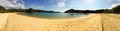 A sweeping panoramic view of a beautiful golden beach and cove in Able Tasman National Park, New Zealand