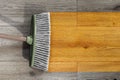 Sweeping wooden floor with broom Royalty Free Stock Photo