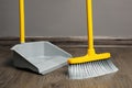 Sweeping wooden floor with plastic broom and dustpan indoors Royalty Free Stock Photo