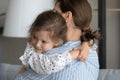 Sweet adorable little girl embracing mom with love