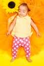 Sweet African baby sleeping on sunflower cloth Royalty Free Stock Photo