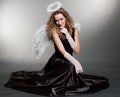 Sweet angel sitting on the floor Royalty Free Stock Photo