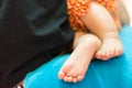 Sweet Asian baby`s feet on her mother`s lap Royalty Free Stock Photo