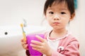 Sweet Asian child little girl brushing her teeth