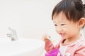 Sweet Asian child little girl brushing her teeth Royalty Free Stock Photo