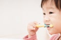 Sweet Asian child little girl brushing her teeth Royalty Free Stock Photo