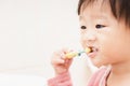 Sweet Asian child little girl brushing her teeth Royalty Free Stock Photo