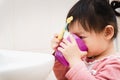 Sweet Asian child little girl brushing her teeth Royalty Free Stock Photo