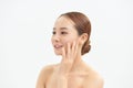 A sweet Asian girl with a clean perfect face closed her eyes with tenderness touching the skin Royalty Free Stock Photo