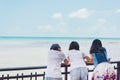 Sweet Asian girls standing behind fence and enjoy fresh air Royalty Free Stock Photo