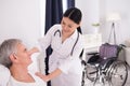 Nurse assisting disabled man. Royalty Free Stock Photo