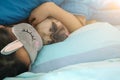 Sweet asian woman with mask and cute puppy pug dog is sleeping r Royalty Free Stock Photo