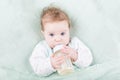 Sweet baby with big blue eyes drinking milk Royalty Free Stock Photo