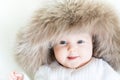 Sweet baby in a big fur hat Royalty Free Stock Photo