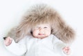 Sweet baby in a big fur hat Royalty Free Stock Photo
