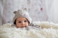 Sweet baby boy in bear overall, sleeping in bed with teddy bear Royalty Free Stock Photo