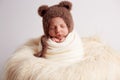 Sweet baby boy in bear overall, sleeping in bed with teddy bear stuffed toys, winter landscape behind him Royalty Free Stock Photo