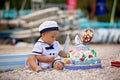 Sweet baby boy, celebrating first birthday with sea theme cake and decoration Royalty Free Stock Photo