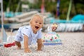Sweet baby boy, celebrating first birthday with sea theme cake and decoration Royalty Free Stock Photo