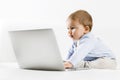 Sweet baby boy looking with curiosity at laptop screen. Royalty Free Stock Photo