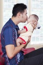 Sweet baby with dad on sofa at home Royalty Free Stock Photo