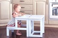 Sweet Baby Eats by herself at a Small Folding Ladder-Table Chair.