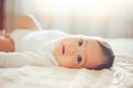 Baby girl on her stomach. Looking up with surprised expression. Royalty Free Stock Photo