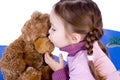 A sweet baby girl kiss her teddy