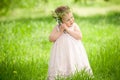 Sweet baby girl outdoors with a bouquet of lilies