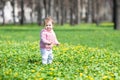 Sweet baby girl playing in a sunny spring park Royalty Free Stock Photo