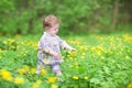 Sweet baby girl playing with yellow flowers Royalty Free Stock Photo