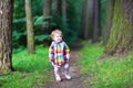 Sweet baby girl in rain jacket walking in autumn p Royalty Free Stock Photo