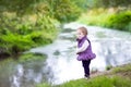 Sweet baby girl at river shore in autumn park Royalty Free Stock Photo