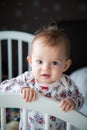 Sweet baby girl standing in her bed Royalty Free Stock Photo